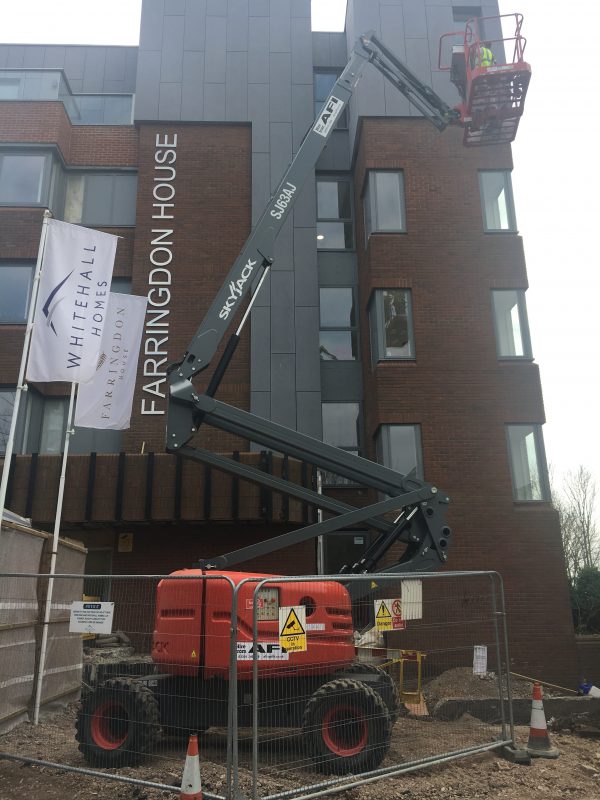 Using a skyjack to install external signage